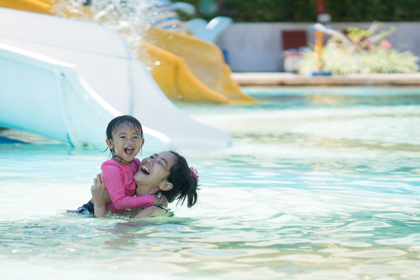 A parent ensuring waterpark safety for her child